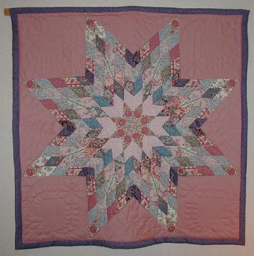 image title is Scrappy Star, Hand Quilted, 1992